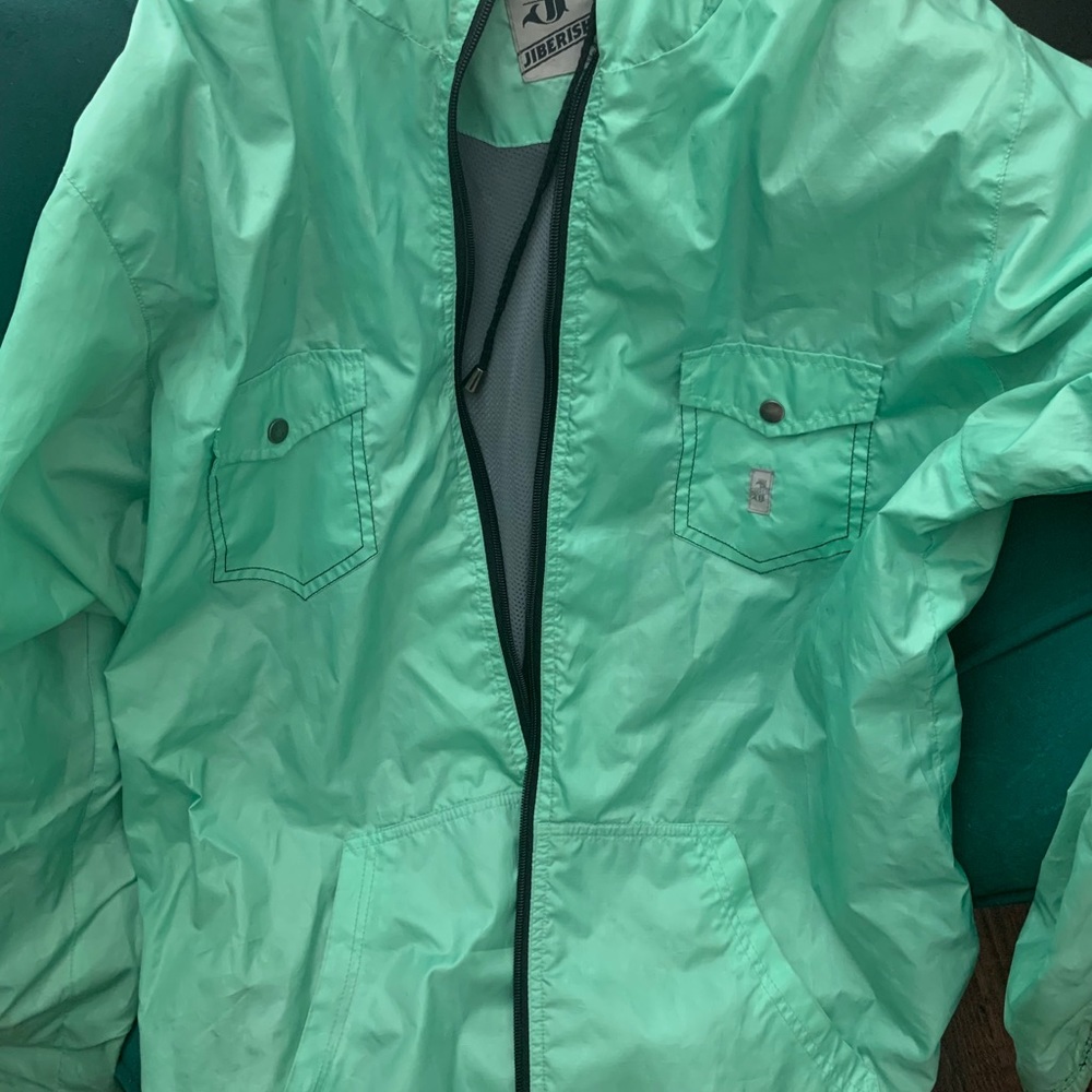 Teal green jibberish windbreaker